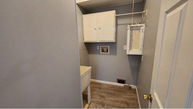 146 Elodie Ave, Harahan, LA 70123 - washroom with hookup for a washing machine, baseboards, cabinet space, and wood finished floors