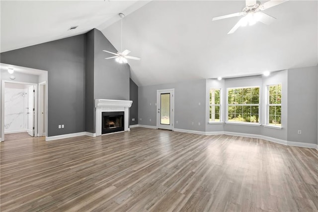 39311 Okefenokee Rd, Pearl River, LA 70452 - unfurnished living room with a ceiling fan, a fireplace, wood finished floors, baseboards, and high vaulted ceiling