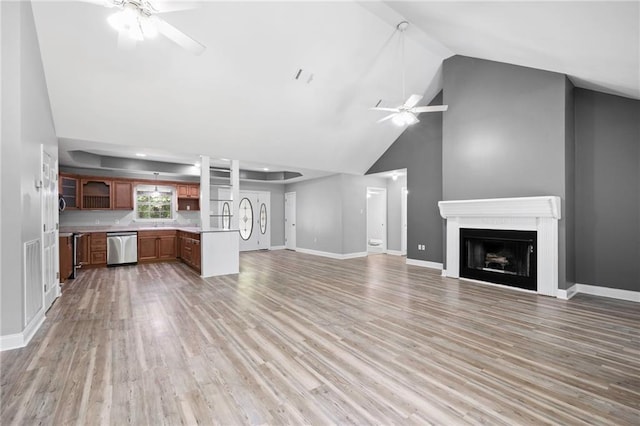 39311 Okefenokee Rd, Pearl River, LA 70452 - unfurnished living room with a ceiling fan, high vaulted ceiling, a fireplace, light wood finished floors, and baseboards