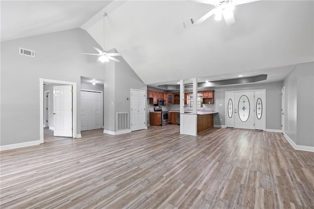 39311 Okefenokee Rd, Pearl River, LA 70452 - unfurnished living room with a ceiling fan, high vaulted ceiling, light wood-style flooring, and baseboards