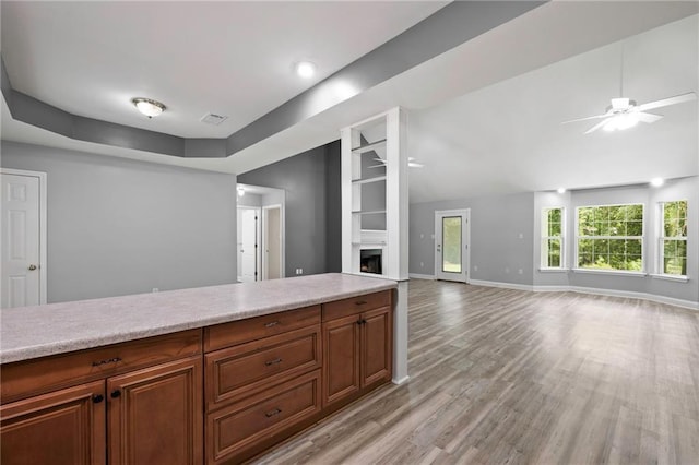 39311 Okefenokee Rd, Pearl River, LA 70452 - kitchen featuring light countertops, a ceiling fan, light wood-style flooring, a fireplace, and lofted ceiling