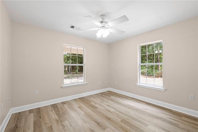 39311 Okefenokee Rd, Pearl River, LA 70452 - empty room with light wood finished floors, plenty of natural light, ceiling fan, and baseboards