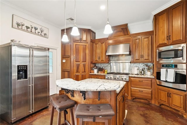 404 Warrior Trce, Covington, LA 70435 - kitchen featuring stainless steel appliances, extractor fan, brown cabinetry, tasteful backsplash, and light stone counters