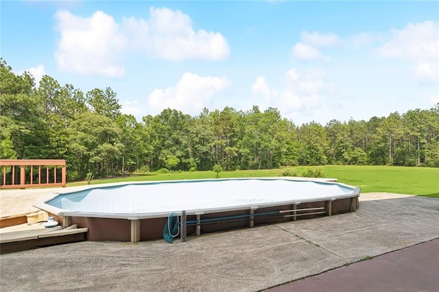 404 Warrior Trce, Covington, LA 70435 - view of swimming pool featuring a wooded view and a lawn
