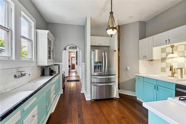 717 Nunez St, New Orleans, LA 70114 - kitchen with stainless steel appliances, dark wood-type flooring, arched walkways, a sink, and white cabinets
