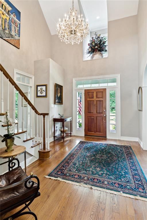 42532 S Range Rd, Hammond, LA 70403 - entryway with a towering ceiling, healthy amount of natural light, stairway, a chandelier, and wood finished floors
