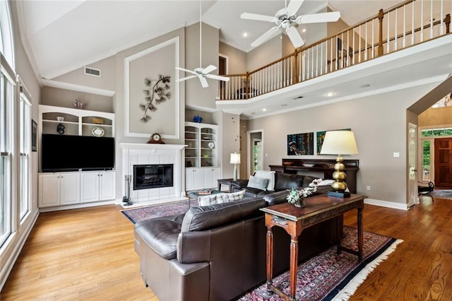 42532 S Range Rd, Hammond, LA 70403 - living room featuring a ceiling fan, a fireplace, healthy amount of natural light, baseboards, and high vaulted ceiling