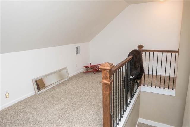 28209 Honey Beagle Ln, Ponchatoula, LA 70454 - stairway featuring vaulted ceiling, carpet floors, and baseboards