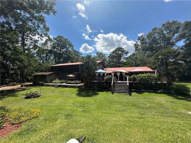 30010 River Rd, Mount Hermon, LA 70450 - view of green lawn with stairs and a deck