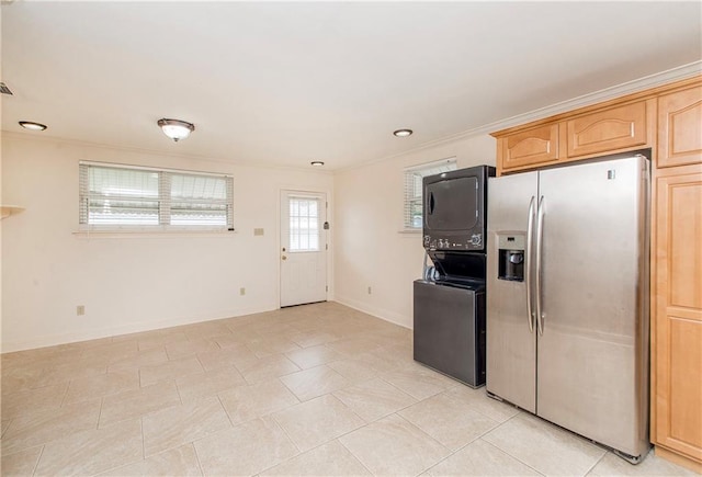 2904 Lloyds Ave, Chalmette, LA 70043 - kitchen with stainless steel fridge, estacked washer and dryer, crown molding, baseboards, and light tile patterned flooring