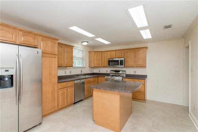2904 Lloyds Ave, Chalmette, LA 70043 - kitchen with appliances with stainless steel finishes, ornamental molding, a kitchen island, a sink, and baseboards