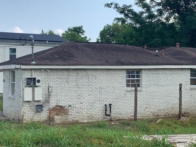 192527 Flood St, New Orleans, LA 70117 - view of side of property with brick siding and a shingled roof