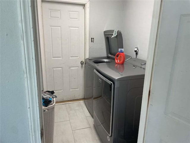 2133 Wellington Ln, Slidell, LA 70461 - laundry room featuring independent washer and dryer and light tile patterned flooring