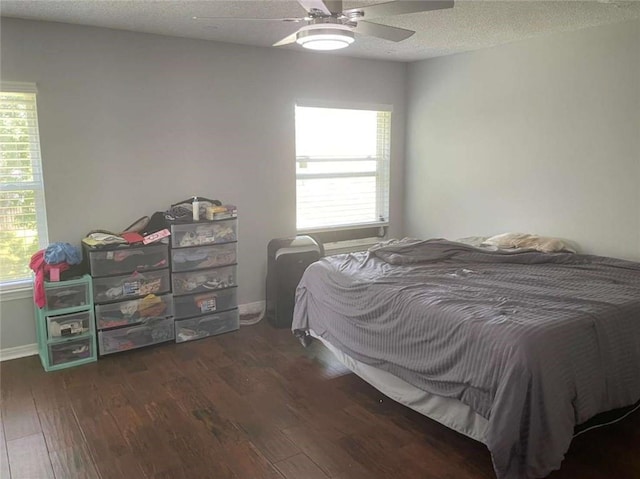 2133 Wellington Ln, Slidell, LA 70461 - bedroom featuring wood finished floors, a textured ceiling, baseboards, and ceiling fan