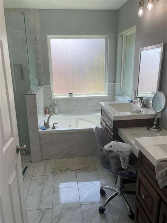 2133 Wellington Ln, Slidell, LA 70461 - bathroom featuring marble finish flooring, a whirlpool tub, vanity, and a stall shower