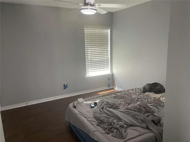 2133 Wellington Ln, Slidell, LA 70461 - bedroom with baseboards, a ceiling fan, and wood finished floors
