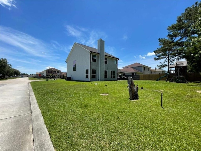 2133 Wellington Ln, Slidell, LA 70461 - view of side of home with a playground and a chimney