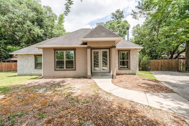 136 Oak Leaf Dr, Slidell, LA 70461 - view of front of property featuring roof with shingles, french doors, and brick siding