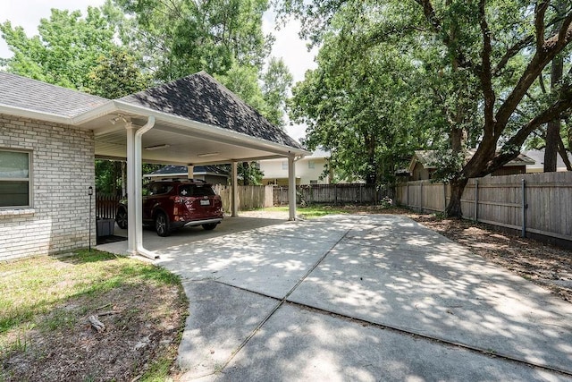 136 Oak Leaf Dr, Slidell, LA 70461 - view of parking featuring concrete driveway and an attached carport