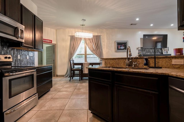 136 Oak Leaf Dr, Slidell, LA 70461 - kitchen featuring stainless steel appliances, a sink, stone countertops, backsplash, and recessed lighting