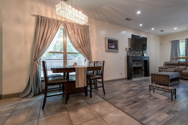 136 Oak Leaf Dr, Slidell, LA 70461 - dining space with a fireplace with flush hearth, baseboards, a chandelier, and recessed lighting