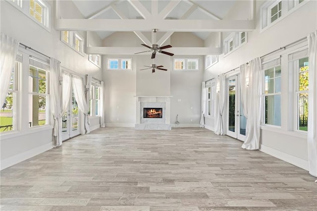 344 Ormond Dr, Covington, LA 70433 - unfurnished living room featuring high vaulted ceiling, wood finished floors, a ceiling fan, a fireplace, and beamed ceiling