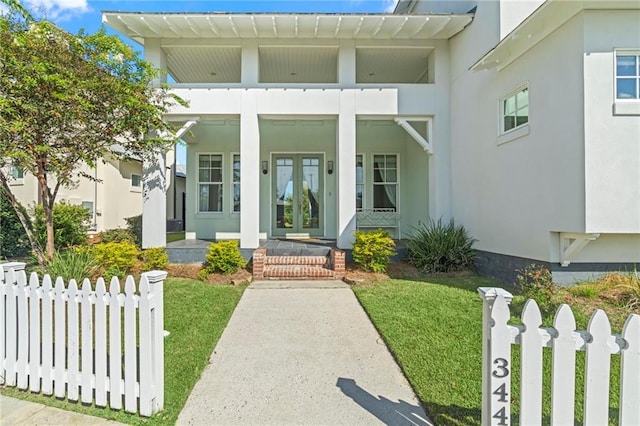344 Ormond Dr, Covington, LA 70433 - entrance to property with french doors, stucco siding, and a porch