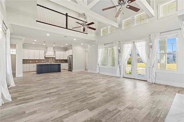 344 Ormond Dr, Covington, LA 70433 - unfurnished living room featuring a ceiling fan, a high ceiling, baseboards, plenty of natural light, and recessed lighting