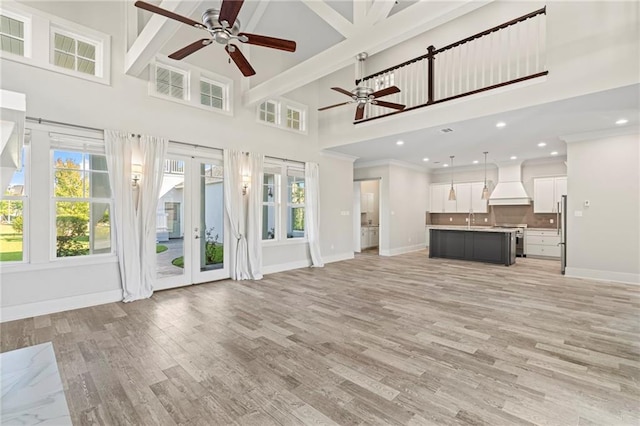 344 Ormond Dr, Covington, LA 70433 - unfurnished living room with ceiling fan, a high ceiling, baseboards, french doors, and healthy amount of natural light