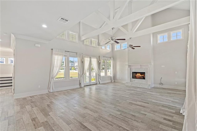 344 Ormond Dr, Covington, LA 70433 - unfurnished living room with high vaulted ceiling, ceiling fan, light wood-type flooring, baseboards, and a premium fireplace