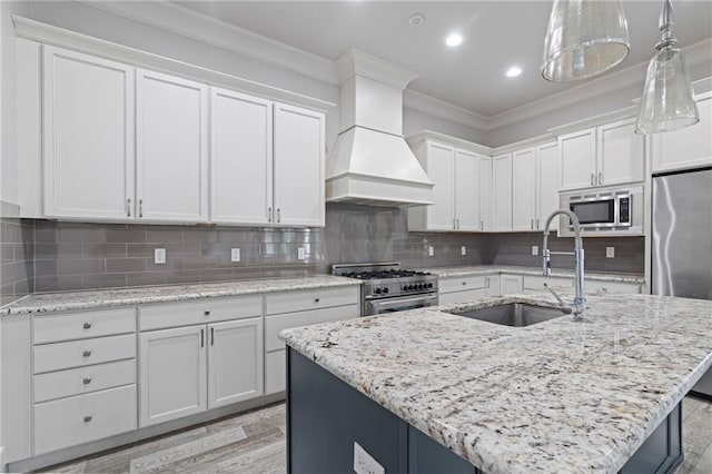 344 Ormond Dr, Covington, LA 70433 - kitchen with appliances with stainless steel finishes, premium range hood, ornamental molding, a sink, and white cabinetry