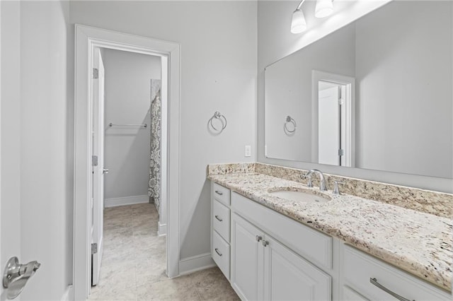 344 Ormond Dr, Covington, LA 70433 - full bathroom with vanity, baseboards, and a shower with curtain