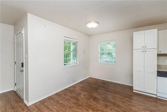 1029 W 32nd Ave, Covington, LA 70433 - unfurnished bedroom with dark wood-type flooring and baseboards