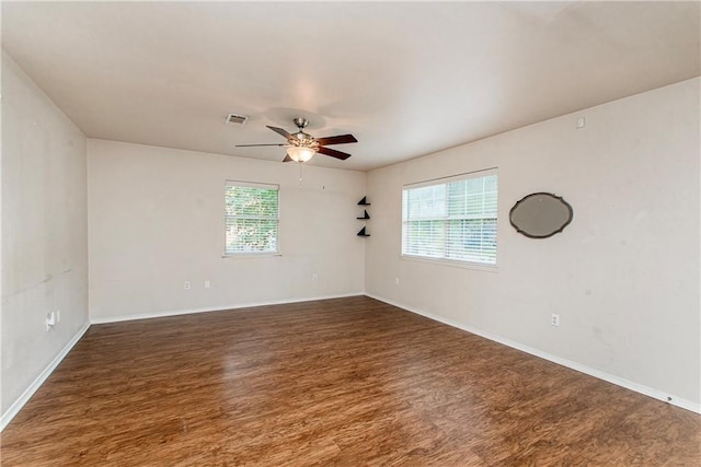 1029 W 32nd Ave, Covington, LA 70433 - empty room with wood finished floors, a ceiling fan, and baseboards