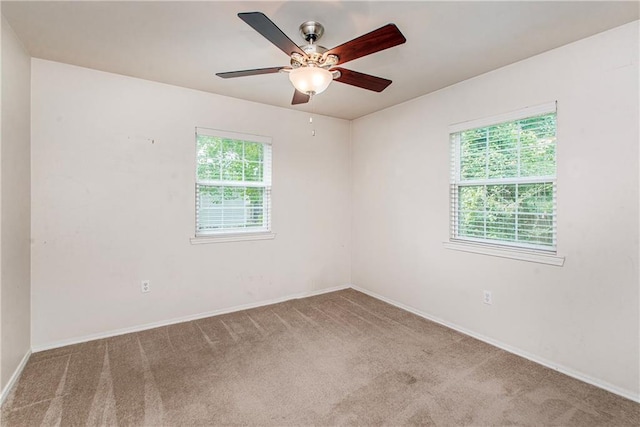 1029 W 32nd Ave, Covington, LA 70433 - carpeted empty room featuring plenty of natural light, baseboards, and ceiling fan