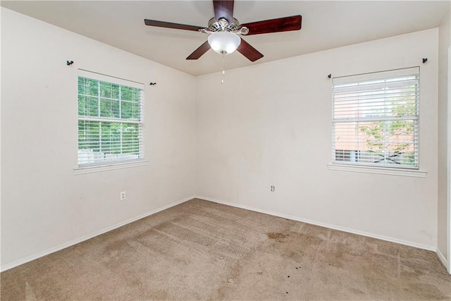 1029 W 32nd Ave, Covington, LA 70433 - empty room with carpet floors, a ceiling fan, and baseboards