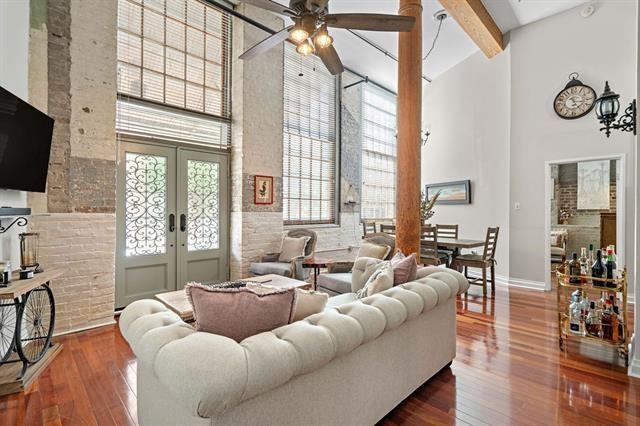 920 Poeyfarre St Unit 176, New Orleans, LA 70130 - living room featuring a towering ceiling, ceiling fan, plenty of natural light, french doors, and wood finished floors