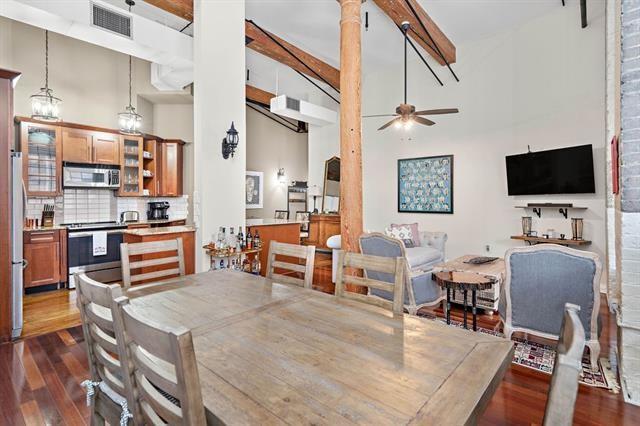 920 Poeyfarre St Unit 176, New Orleans, LA 70130 - dining area with ceiling fan, a high ceiling, dark wood-style floors, and beamed ceiling