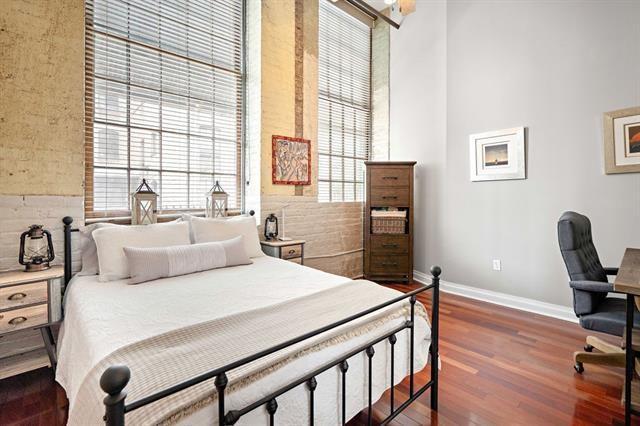 920 Poeyfarre St Unit 176, New Orleans, LA 70130 - bedroom featuring wood finished floors and a high ceiling