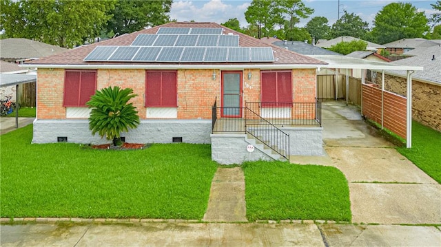 131 Ann St, Saint Rose, LA 70087 - view of front of house featuring brick siding, solar panels, a shingled roof, and a carport