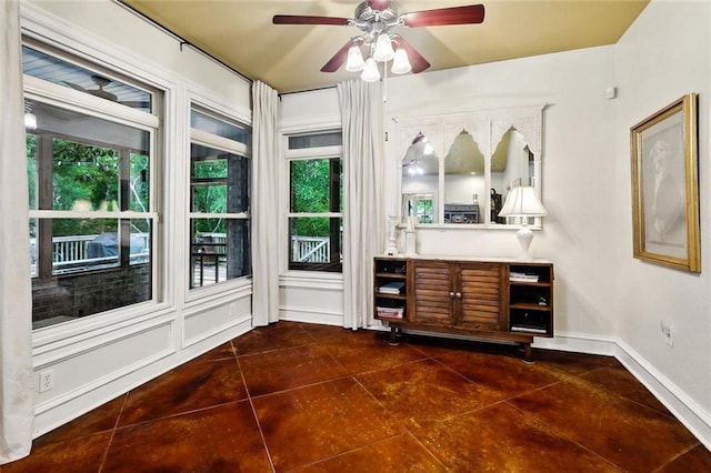 234 Blue Crane 1 Dr, Slidell, LA 70461 - bar with a ceiling fan, baseboards, and dark tile patterned flooring