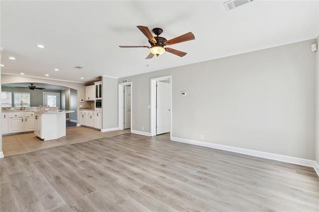 15 E Chalmette Cir, Chalmette, LA 70043 - unfurnished living room featuring a ceiling fan, recessed lighting, baseboards, and light wood-style floors
