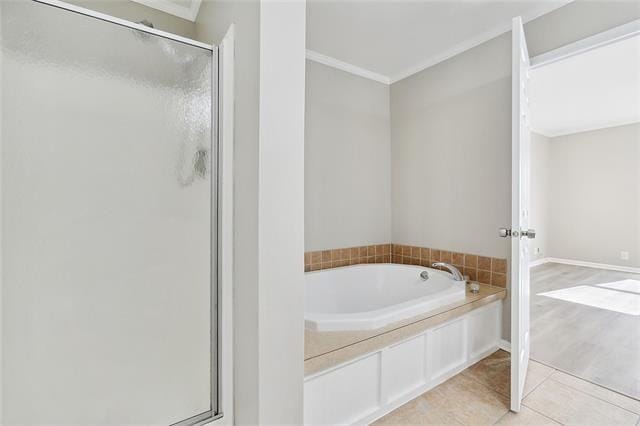 15 E Chalmette Cir, Chalmette, LA 70043 - full bathroom with ornamental molding, a shower stall, a garden tub, and tile patterned flooring