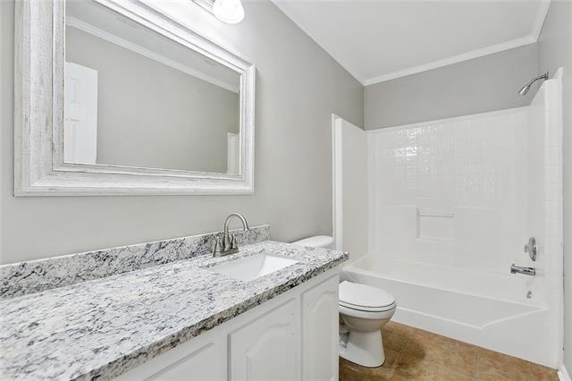 15 E Chalmette Cir, Chalmette, LA 70043 - full bathroom with toilet, vanity, ornamental molding, bathing tub / shower combination, and tile patterned flooring