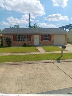 1938 Longwood Ct, La Place, LA 70068 - single story home with driveway, a front yard, and brick siding