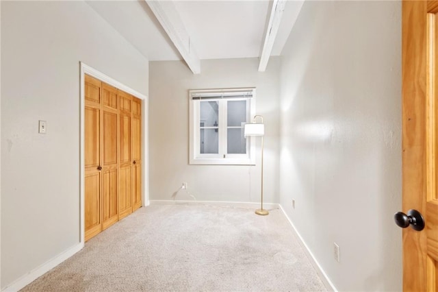 1020 Esplanade Ave Unit 204, New Orleans, LA 70116 - unfurnished bedroom with carpet flooring, beamed ceiling, baseboards, and a closet