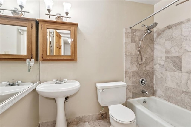 1020 Esplanade Ave Unit 204, New Orleans, LA 70116 - bathroom with toilet, washtub / shower combination, baseboards, and marble look tile flooring