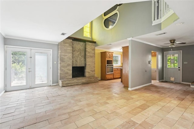 23396 S Maple Dr, Ponchatoula, LA 70454 - unfurnished living room with baseboards, ceiling fan, ornamental molding, a brick fireplace, and french doors