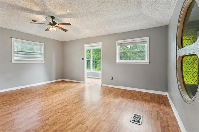 23396 S Maple Dr, Ponchatoula, LA 70454 - unfurnished room with light wood finished floors, a ceiling fan, a textured ceiling, and baseboards
