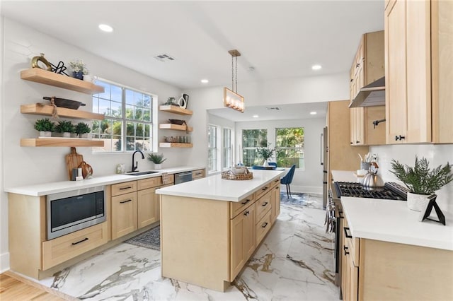 2526 Metairie Rd, Metairie, LA 70001 - kitchen with open shelves, appliances with stainless steel finishes, light brown cabinetry, a kitchen island, and a sink